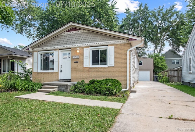 3764 Tyler Ave, Royal Oak, MI 48072 - view of front facade featuring brick siding, a detached garage, and a front yard