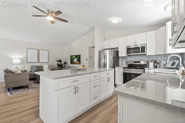 3764 Tyler Ave, Royal Oak, MI 48072 - kitchen with stainless steel appliances, lofted ceiling, ceiling fan, light wood-style floors, and white cabinetry