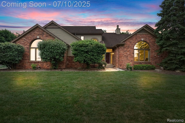 4253 Drexel Dr, Troy, MI 48098 - view of front facade with brick siding, a lawn, a chimney, and roof with shingles