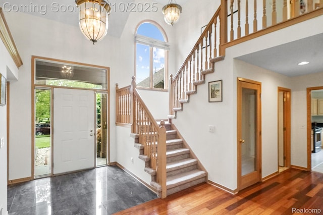 4253 Drexel Dr, Troy, MI 48098 - entrance foyer with a chandelier, a towering ceiling, stairway, and wood finished floors