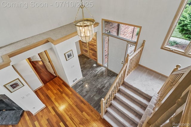 4253 Drexel Dr, Troy, MI 48098 - stairway with a chandelier and wood finished floors