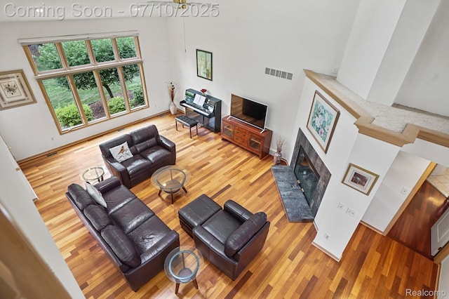 4253 Drexel Dr, Troy, MI 48098 - living room with wood finished floors, a brick fireplace, and a high ceiling