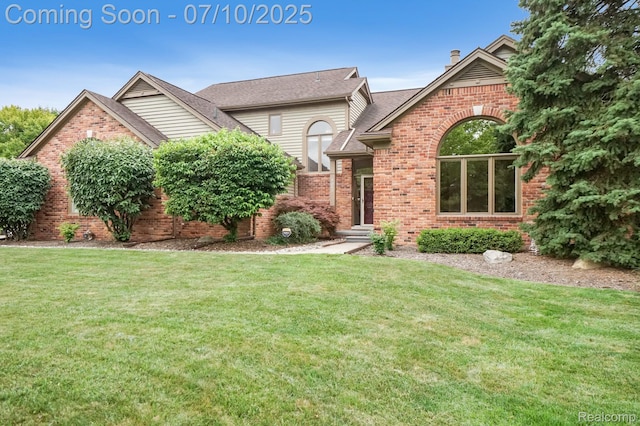 4253 Drexel Dr, Troy, MI 48098 - view of front of house with brick siding, a front yard, and a chimney