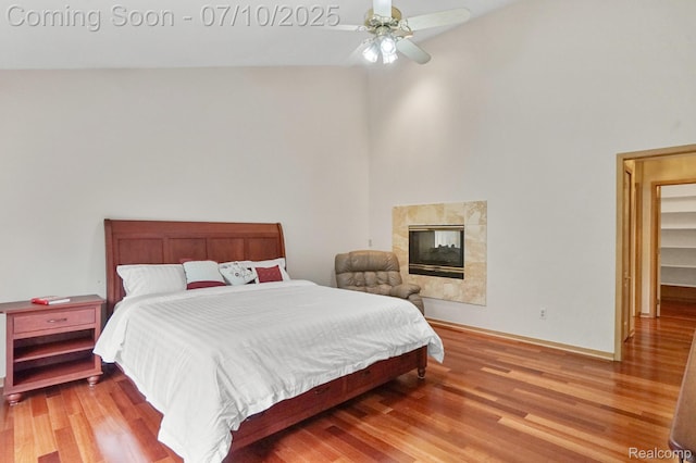 4253 Drexel Dr, Troy, MI 48098 - bedroom with wood finished floors, a fireplace, a ceiling fan, and high vaulted ceiling