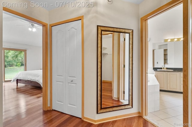 4253 Drexel Dr, Troy, MI 48098 - hallway with a sink and light wood-style flooring