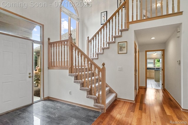 4253 Drexel Dr, Troy, MI 48098 - foyer entrance featuring a high ceiling, stairs, and hardwood / wood-style floors