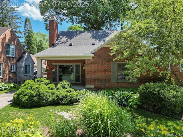 1877 Wiltshire Rd, Berkley, MI 48072 - view of front of house with brick siding, a chimney, and a shingled roof