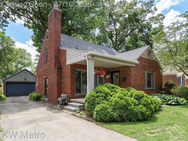 1877 Wiltshire Rd, Berkley, MI 48072 - view of front of property featuring a shingled roof, an outbuilding, brick siding, and a detached garage
