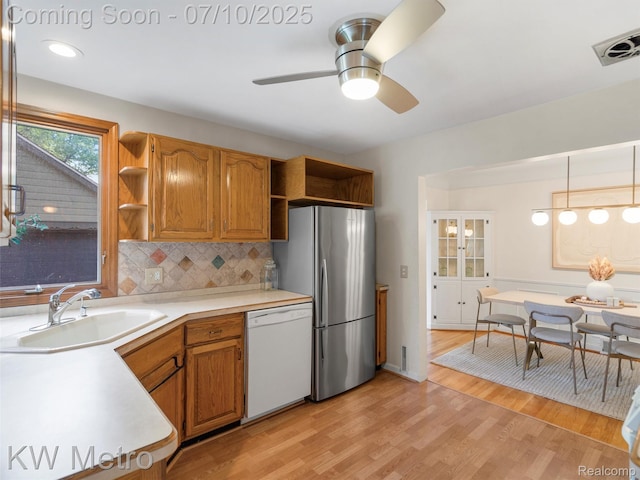 1877 Wiltshire Rd, Berkley, MI 48072 - kitchen featuring dishwasher, open shelves, freestanding refrigerator, light countertops, and light wood-style flooring