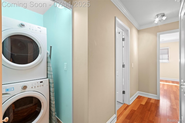 532 E Fox Hills Dr, Bloomfield Hills, MI 48304 - washroom with stacked washing machine and dryer, light wood-type flooring, and ornamental molding