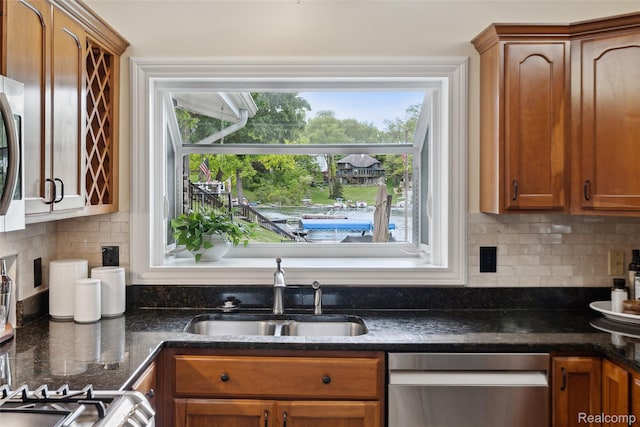 2009 Ridge Rd, White Lake, MI 48383 - kitchen featuring stainless steel dishwasher, dark stone countertops, tasteful backsplash, and brown cabinets