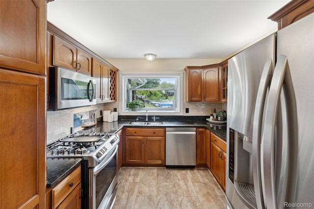2009 Ridge Rd, White Lake, MI 48383 - kitchen with stainless steel appliances, decorative backsplash, brown cabinets, and dark stone counters