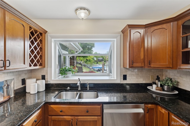2009 Ridge Rd, White Lake, MI 48383 - kitchen featuring stainless steel dishwasher, backsplash, brown cabinets, and dark stone counters