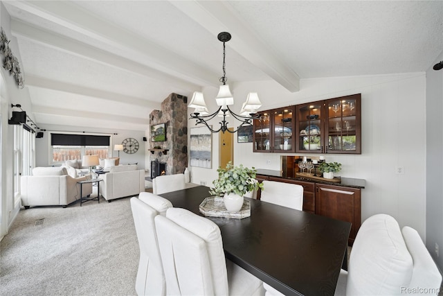 2009 Ridge Rd, White Lake, MI 48383 - dining room featuring a chandelier, beam ceiling, and light carpet