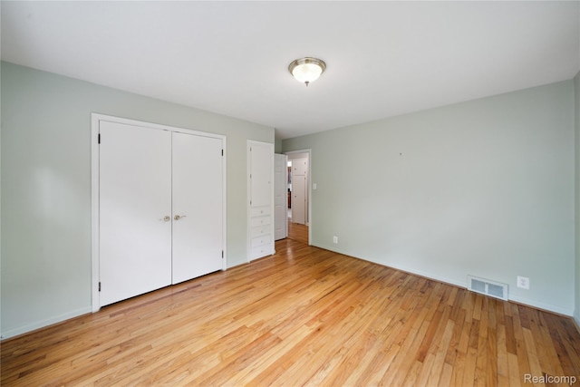 2009 Ridge Rd, White Lake, MI 48383 - unfurnished bedroom with hardwood / wood-style floors and a closet