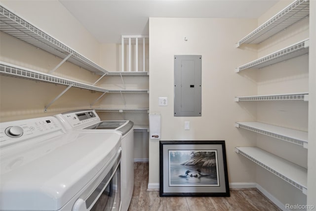 2009 Ridge Rd, White Lake, MI 48383 - laundry room with electric panel, washer and clothes dryer, and wood finished floors