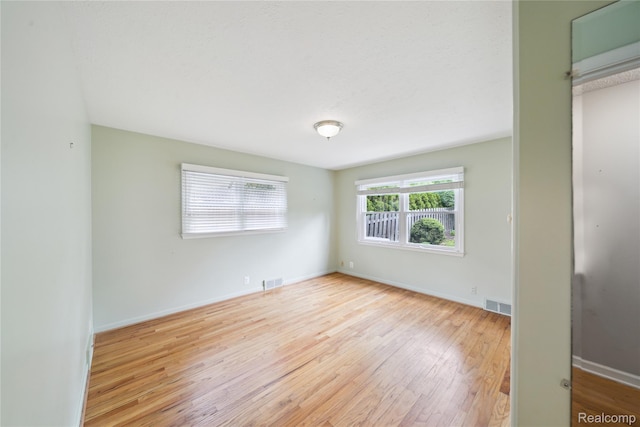 2009 Ridge Rd, White Lake, MI 48383 - unfurnished bedroom with wood finished floors and baseboards