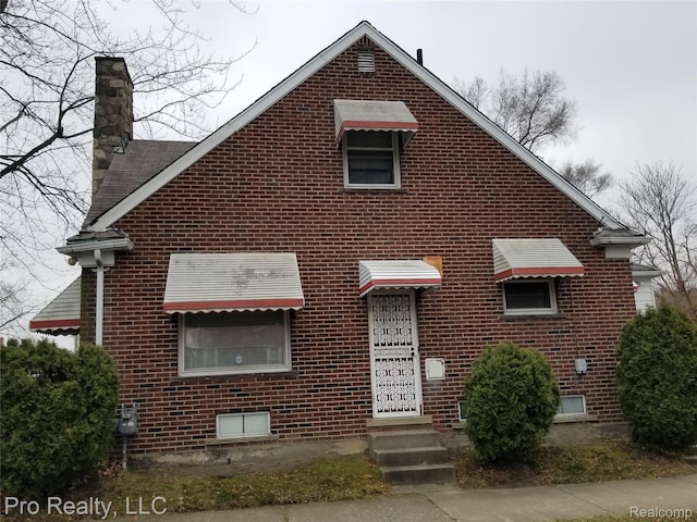 17211 Monica St, Detroit, MI 48221 - view of front of house with brick siding and a chimney