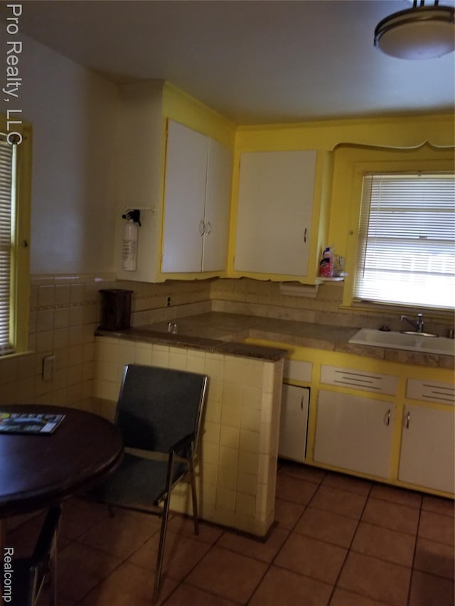 17211 Monica St, Detroit, MI 48221 - kitchen with white cabinets, tile patterned floors, and tile countertops