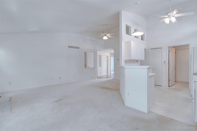 37306 Amhurst Dr, Westland, MI 48185 - unfurnished living room featuring ceiling fan, light colored carpet, and high vaulted ceiling