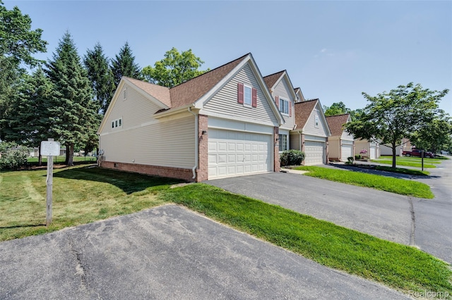 37306 Amhurst Dr, Westland, MI 48185 - traditional home with asphalt driveway, a front yard, and brick siding