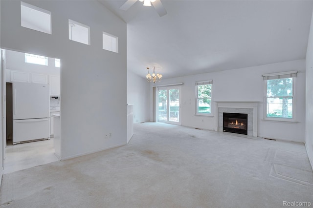 37306 Amhurst Dr, Westland, MI 48185 - unfurnished living room with a premium fireplace, light colored carpet, a chandelier, high vaulted ceiling, and a ceiling fan