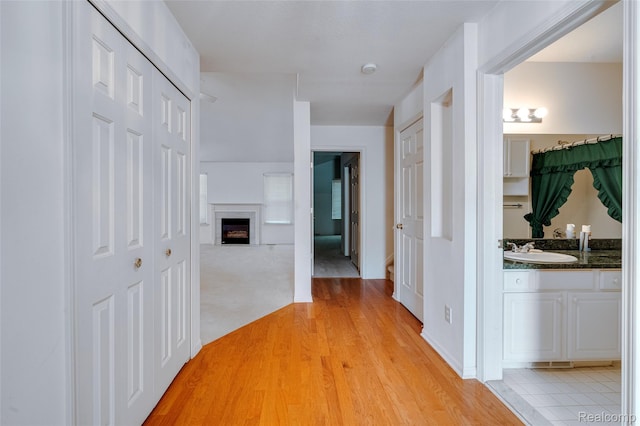 37306 Amhurst Dr, Westland, MI 48185 - hallway featuring a sink and light wood finished floors