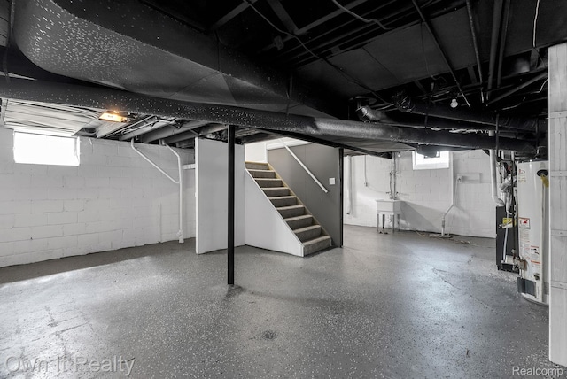 1389 Cleveland Ave, Northville, MI 48146 - below grade area featuring stairway, water heater, and plenty of natural light