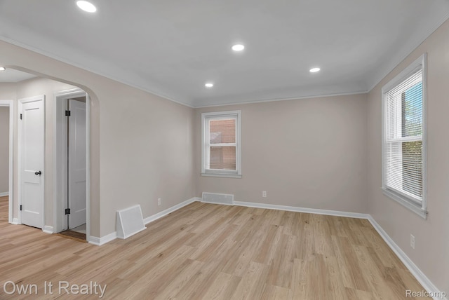 1389 Cleveland Ave, Northville, MI 48146 - unfurnished room featuring arched walkways, light wood-type flooring, ornamental molding, and recessed lighting