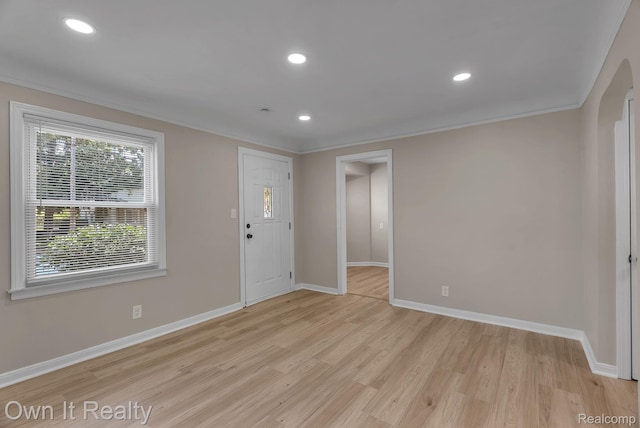 1389 Cleveland Ave, Northville, MI 48146 - entryway featuring crown molding, light wood finished floors, recessed lighting, and arched walkways