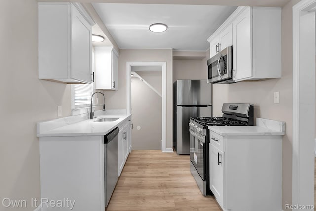 1389 Cleveland Ave, Northville, MI 48146 - kitchen with appliances with stainless steel finishes, light wood finished floors, white cabinets, and light countertops