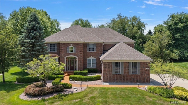 8507 Newbury Ct N, Canton, MI 48187 - colonial inspired home with a front lawn, brick siding, and roof with shingles