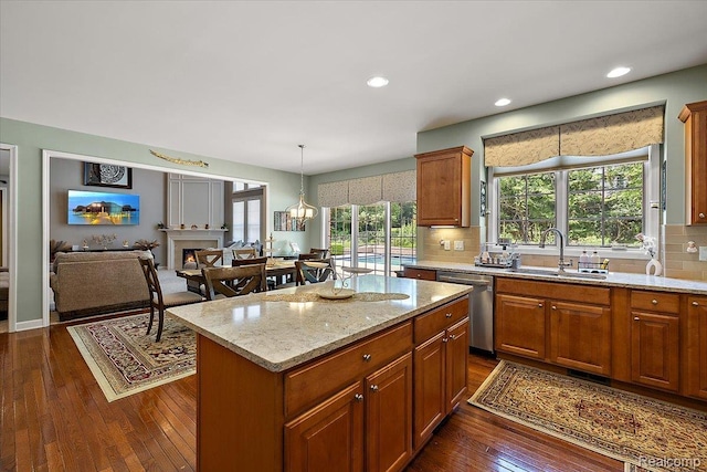 8507 Newbury Ct N, Canton, MI 48187 - kitchen with dishwasher, dark wood-style floors, decorative backsplash, light stone countertops, and a kitchen island