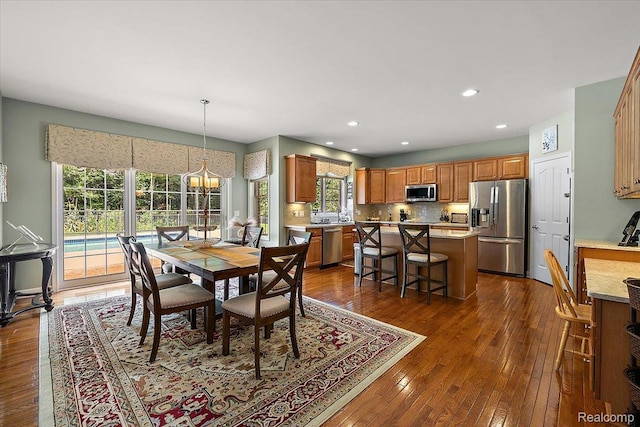 8507 Newbury Ct N, Canton, MI 48187 - dining space featuring dark wood-type flooring, recessed lighting, and a chandelier