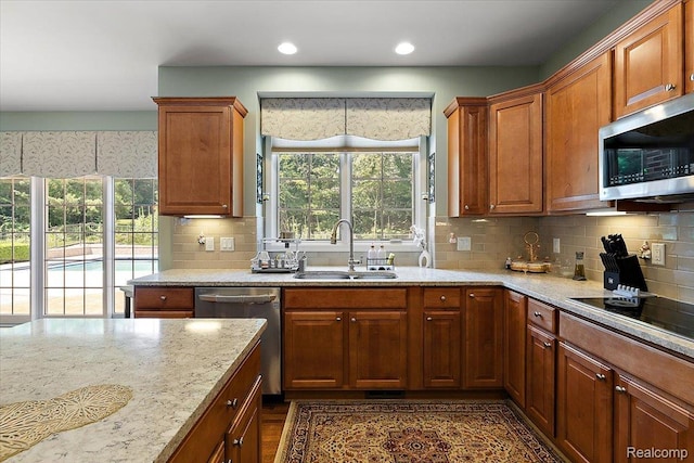 8507 Newbury Ct N, Canton, MI 48187 - kitchen with stainless steel appliances, healthy amount of natural light, backsplash, light stone countertops, and recessed lighting