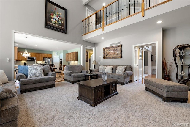 8507 Newbury Ct N, Canton, MI 48187 - living area featuring a towering ceiling, light colored carpet, and recessed lighting