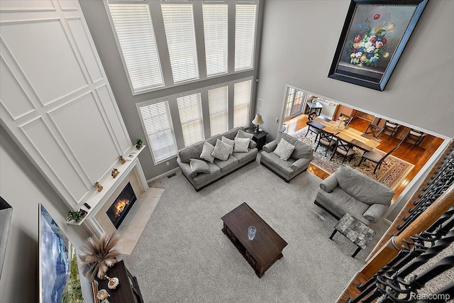 8507 Newbury Ct N, Canton, MI 48187 - living room with a towering ceiling, a fireplace, and carpet