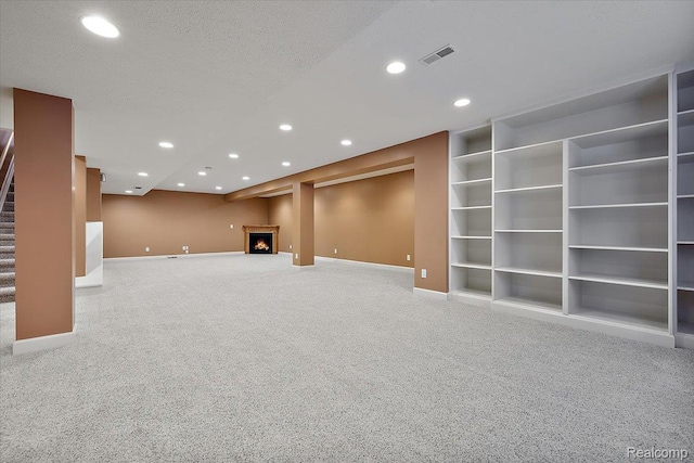 8507 Newbury Ct N, Canton, MI 48187 - finished below grade area featuring carpet, stairway, recessed lighting, built in shelves, and a warm lit fireplace