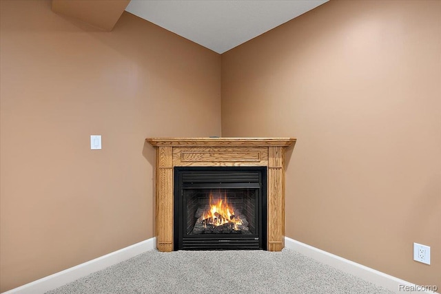 8507 Newbury Ct N, Canton, MI 48187 - detailed view of carpet flooring and a lit fireplace