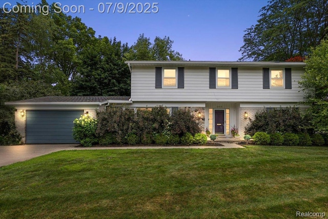 32010 Inglewood St, Franklin, MI 48025 - colonial house featuring an attached garage, a front lawn, driveway, and brick siding