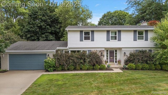 32010 Inglewood St, Franklin, MI 48025 - view of front of house with brick siding, a garage, concrete driveway, and a front yard