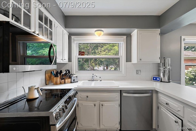 32010 Inglewood St, Franklin, MI 48025 - kitchen featuring stainless steel appliances, white cabinetry, tasteful backsplash, light countertops, and glass insert cabinets