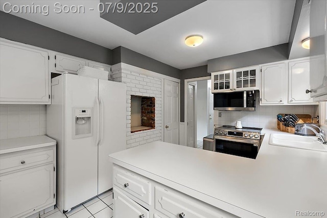 32010 Inglewood St, Franklin, MI 48025 - kitchen with appliances with stainless steel finishes, backsplash, white cabinetry, and light countertops