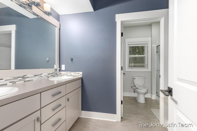 7979 Ella Terrace Dr, Rockford, MI 49341 - full bath with double vanity and wood finished floors