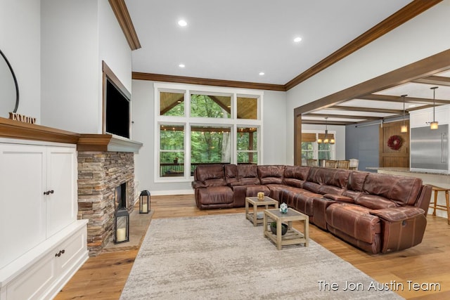 7979 Ella Terrace Dr, Rockford, MI 49341 - living room featuring crown molding, light wood-style floors, a chandelier, a fireplace, and recessed lighting