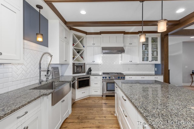 7979 Ella Terrace Dr, Rockford, MI 49341 - kitchen with stainless steel appliances, wall chimney range hood, open shelves, white cabinetry, and backsplash