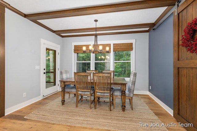 7979 Ella Terrace Dr, Rockford, MI 49341 - dining space with beam ceiling, light wood-style flooring, and a chandelier