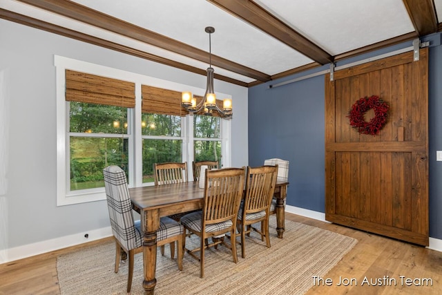 7979 Ella Terrace Dr, Rockford, MI 49341 - dining room featuring plenty of natural light, a chandelier, beamed ceiling, and light wood-type flooring