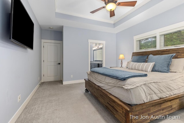 7979 Ella Terrace Dr, Rockford, MI 49341 - bedroom with a tray ceiling, carpet, connected bathroom, ornamental molding, and ceiling fan