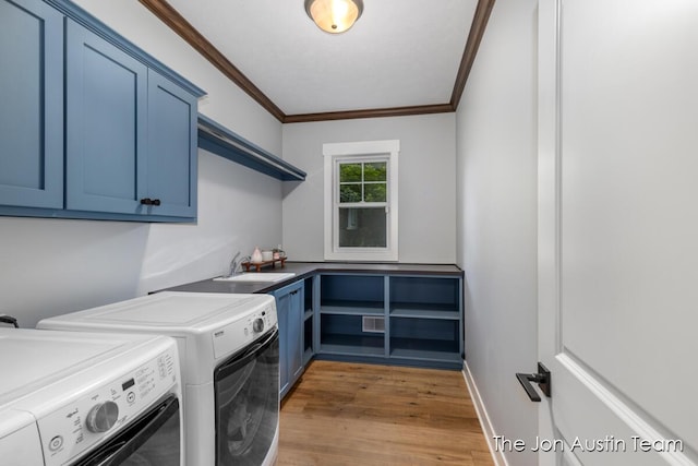 7979 Ella Terrace Dr, Rockford, MI 49341 - washroom with cabinet space, independent washer and dryer, ornamental molding, and light wood-style flooring